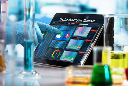 scientist working experiment with a computer in the laboratory / researcher working with data analysis report in digital tablet of the labの写真素材