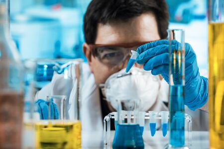 Chemist holding tube in the laboratory / Researcher engineer holding test tube in the investigation labの写真素材
