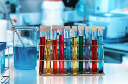 tube tray with colored fluids for analysis in the lab / rack with test tubes in the research...