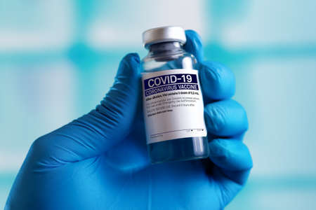 Doctor with vial for research and development of the vaccine for new variants of the covid-19 virus....