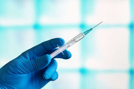 anesthetist in cosmetic surgery clinic with a syringe to anesthetize a patient before the...