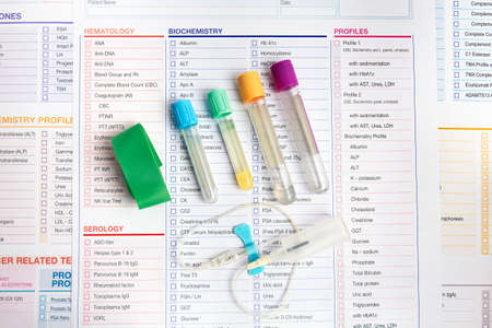 Equipment of vacuum sample tubes and needle for blood draw. Blood tubes test Set and requisition form for analysis in the worplace of laboratoryの写真素材