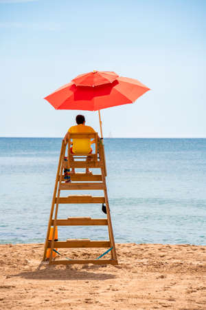 lifeguard under the umbrella watching overの写真素材