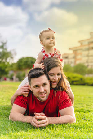 Portrait of happy young Family lying on grassの写真素材