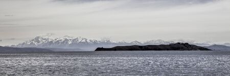 Island of the moon with snowy mountains in the backgroundの写真素材