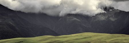 Dramatic view of clouds, mountains and grass in Los Yungas, Bolivia