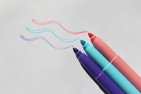 Felt-tip pens on a white background with drawing lines