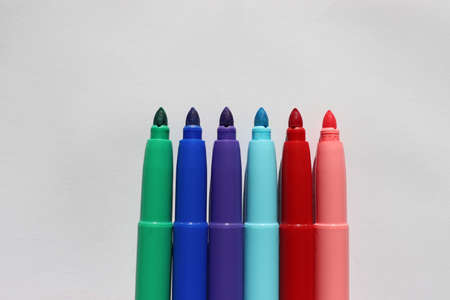 Felt-tip pens in a row on a white background