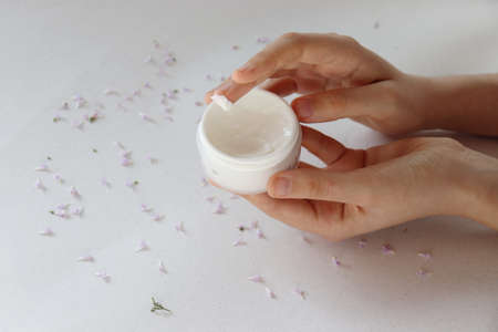 Finger dipped in a face cream on white backgroundの写真素材