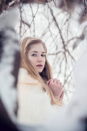 beautiful fabulous blonde girl in the snow with mirrorの写真素材