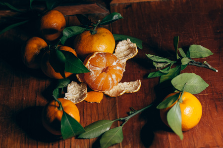 Beautiful Christmas decoration with tangerines in the night light garlands. Citrus still life. The symbol of the new yearの写真素材