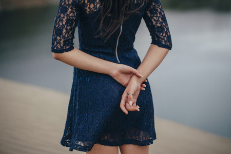 Lifestyle portrait of a woman brunette on the background of the lake in the sand on a cloudy day. Romantic, gentle, mystical, pensive image of a girl. Girl Oriental appearanceの写真素材