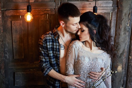 Bride and groom are getting ready in the morning for the wedding. Loving couple hugging at home. Handsome groom and charming bride. Couple get ready  wedding ceremonyの写真素材
