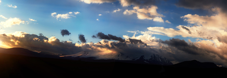 Altai Ukok the sunset over the mountains in cloudy cold weather. Wild remote places, no one around. Rain clouds over the mountainsの写真素材