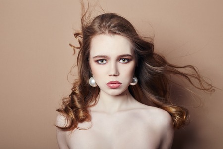 Sexy young blonde girl hair jewelry on her neck and earrings in her ears, beautiful eyes. Summer...
