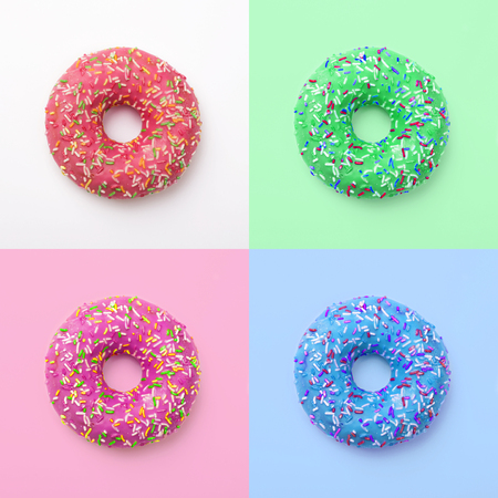 Set of colorful donuts in icing on a colored background. Excellent fresh delicious purple green blue...