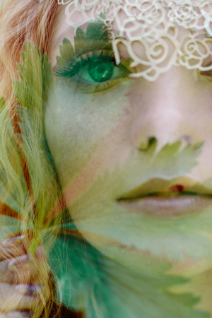 Portrait of a woman with a double exposure, the girl and the blurred nature of the photo is not in...