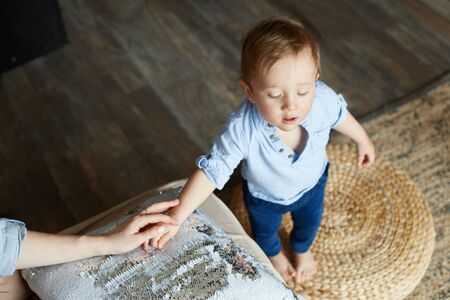 Father and son play and have fun at home. Happy family life. A man holding the hand of a child. A...