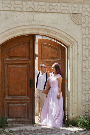Couple in love walks and hugs on beautiful streets ancient city on summer day. Wedding couple waiting wedding ceremonyの写真素材