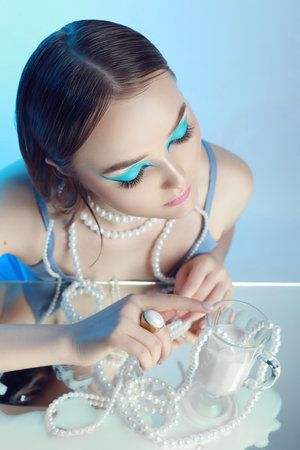 Portrait woman with bright colored eyes, all shades of purple blue. Short Hair, beautiful lips and makeup. Blue shadow eyelids. Sexy girl with short hair. professional makeupの写真素材