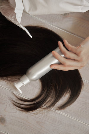 Happy Young Adult Woman with Long black Hair Indoors in Casual Clothingの写真素材