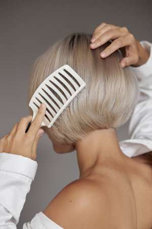 Happy Woman with Blond Hair in Casual Clothing and Fashionable Hairstyleの写真素材