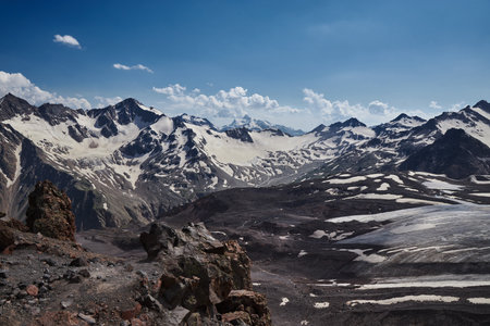 Nestled in Russia Caucasus, majestic mountain landscape captivates with its snow covered peaks, serene glaciers and rugged rock formationsの写真素材