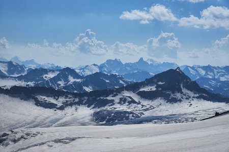 Nestled in Russia Caucasus, majestic mountain landscape captivates with its snow covered peaks, serene glaciers and rugged rock formationsの写真素材
