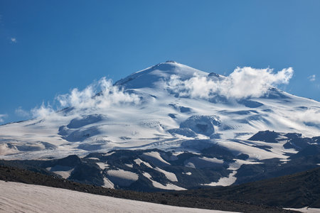Russia Caucasus, Mount Elbrus towers majestically, adorned in pristine snow and ice. Alpine...