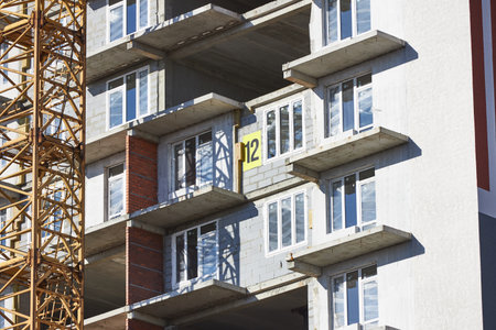 high-rise construction site features concrete floors with framed windows and a large number marking...