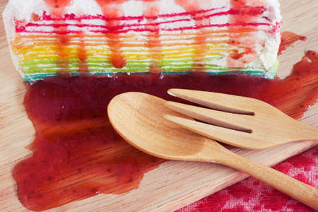 Rainbow crepe cake on wooden board. Relaxing styleの写真素材