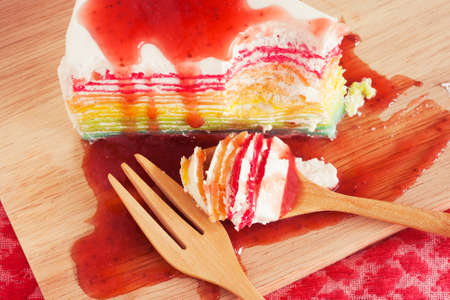 Rainbow crepe cake on wooden board. Relaxing styleの写真素材