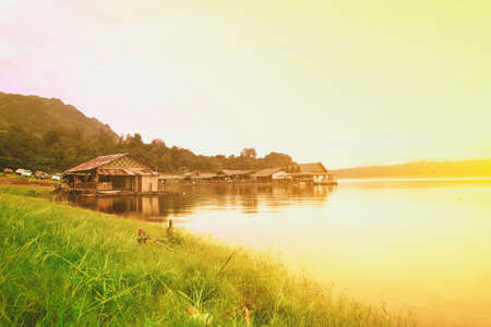 Waterfront Home at evening in srinakarin Dam in Kanchanaburi. Colorful Styleの写真素材