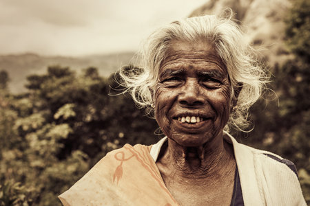 Ella, Sri Lanka. July 27, 2016: Old smiling indian woman. Elderly wrinkles. White hair and worn...