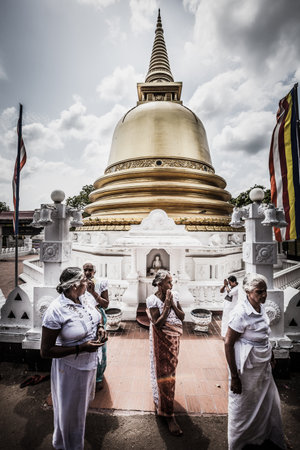 Dambulla, Sri Lanka. July 22, 2016: Women in traditional Sri Lankan dress in Dambulla near the Golden Temple Peace Pagoda Stupa.のeditorial素材