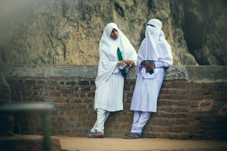 Sigirya, Sri Lanka. July 20, 2016: Two Arab women are relaxed and talking to each other at Sigiriya in Sri Lanka. Wear the typical dress of Muslim and Arab culture.のeditorial素材