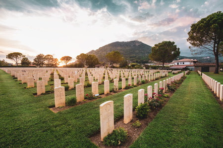 Cassino / Italy - August 17, 2019: War memorial Canadian tombstone with epitaph. Commonwealth Cemetery of Cassino in Italy of the Second World War. Canada heroes, leaf symbol. Sunset.のeditorial素材
