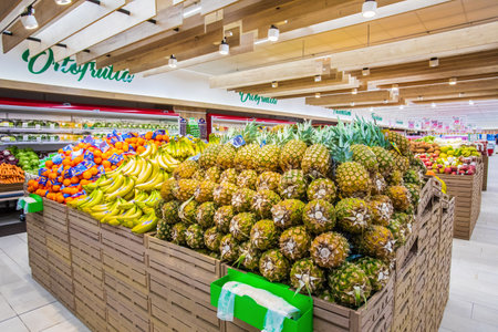 Fruit and vegetable department with numerous varieties of fruit exposed inside a MA supermarket in Italy in Rome. Crates of fruit and vegetables in a large space.のeditorial素材