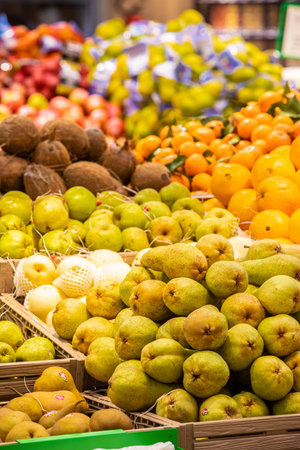 Fruit and vegetable department with numerous varieties of fruit exposed inside a MA supermarket in Italy in Rome. Crates of fruit and vegetables in a large space.のeditorial素材
