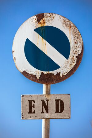 Road sign prohibiting access, at the bottom a sign with the word end. In the background a blue sky....