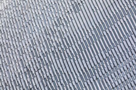 Skyscraper wall abstract background with repeated rectangular cells. Metal gray color with...