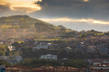 Montesilvano, Italy. May 19, 2019: Idyllic hilly landscape with houses and cloudy sky over sunset. Montesilvano, Italy.のeditorial素材