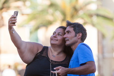 Porto Azzurro, Italy. June 26, 2016: Happy couple doing a selfie. Elba Island, in the Tuscany region in Italy. Overweight woman.のeditorial素材