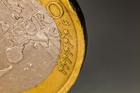 Euro coin macro, one euro. Close-up photography and details of one euro coin. Image taken with a macro professional lens. Gray background.の写真素材