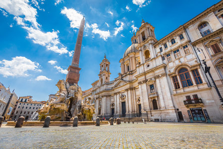 Rome, Italy. May 25, 2020: Santa Agnese in Agone, 17th-century Baroque church in Rome, Italy and Fontana dei Quattro Fiumi Fountain of the Four Rivers. Blue sky.のeditorial素材