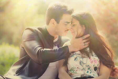 Young couple loving outdoors in a park. A young man and young woman embracing e kissing with passion and feeling. Love and falling in love. Black and whiteの写真素材