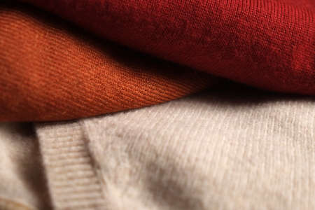 Three folded woolen sweatersの写真素材