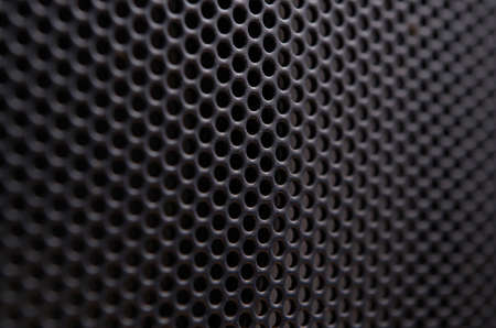 Close up of a black gray protective metal net of a speakerの写真素材