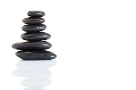 Stack of spa hot stones isolated on white backgroundの写真素材