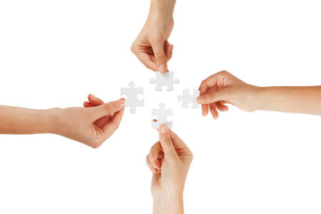 puzzle in hands isolated on white backgroundの写真素材